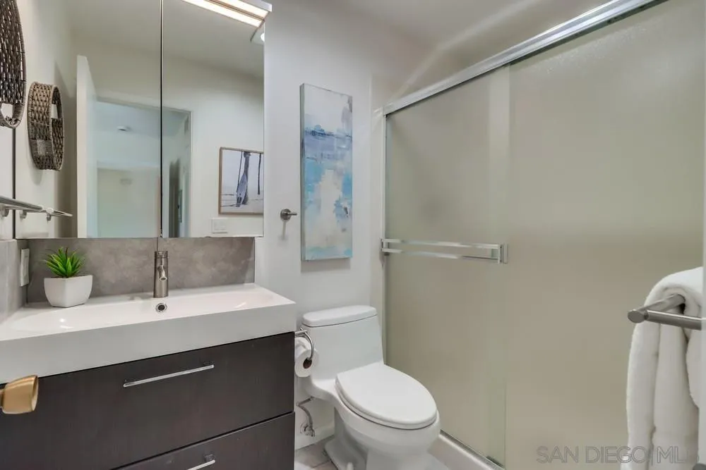 2244 2nd Avenue, Unit 25 San Diego, CA 92101 - Photo 15 of 27 a bathroom with a sink toilet and shower