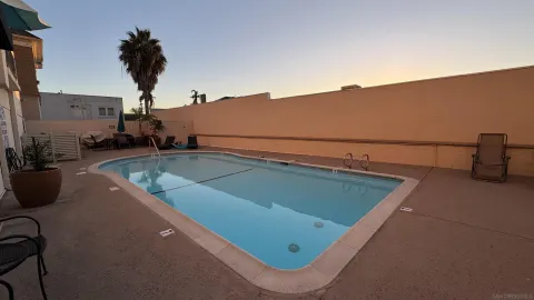 a view of a room with a table and chairs