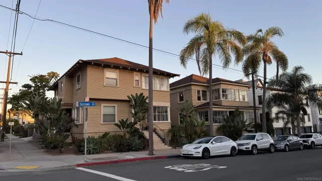 a couple of cars parked in front of a house
