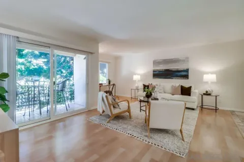 a living room with furniture a large window and a fireplace