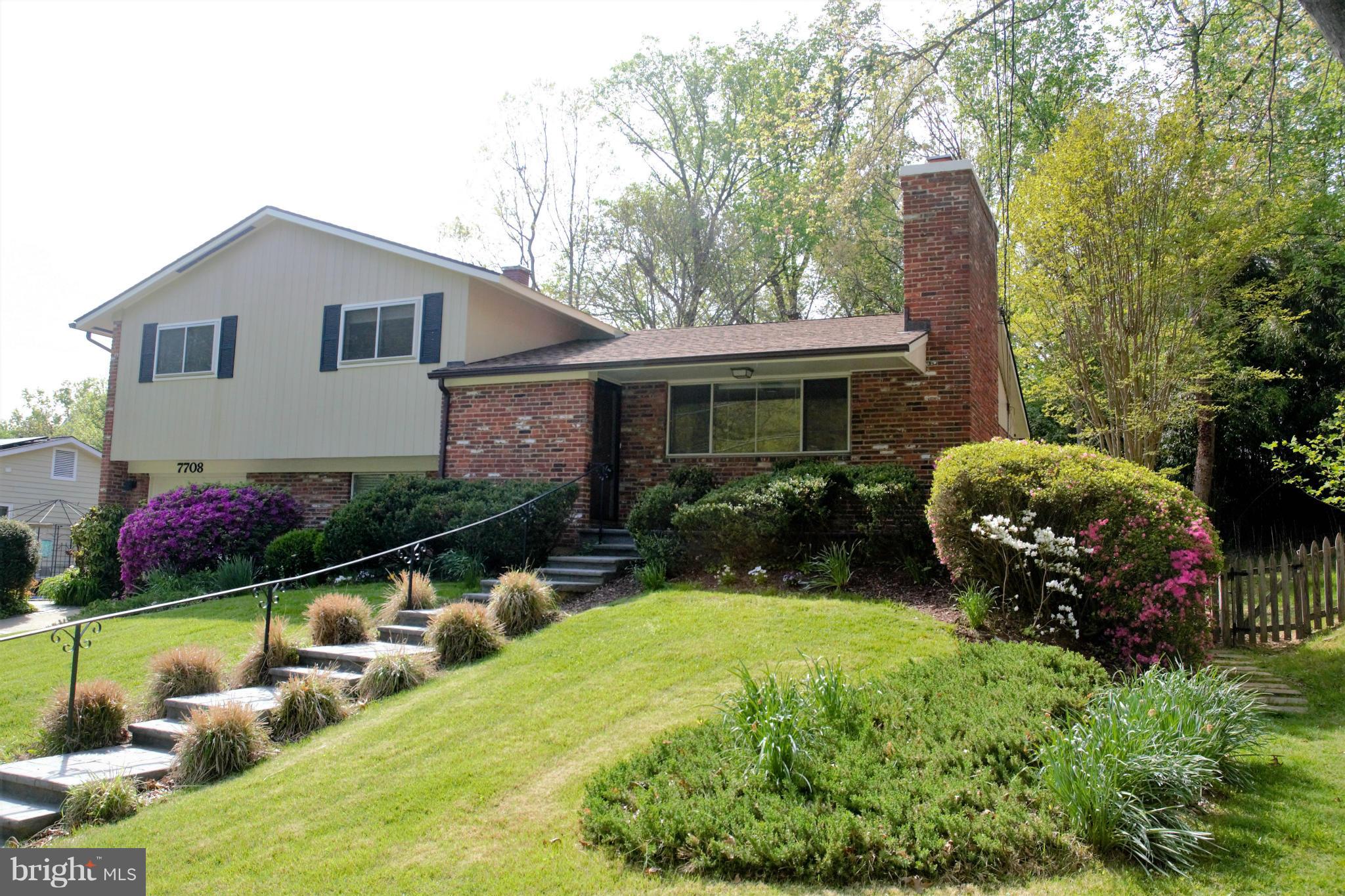 7708 Beech Tree Road Bethesda, MD 20817 - Photo 2 of 30 a front view of a house with porch and garden