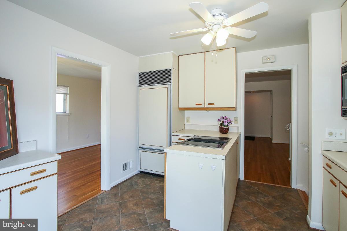 7708 Beech Tree Road Bethesda, MD 20817 - Photo 11 of 30 a kitchen with a stove a refrigerator and a sink