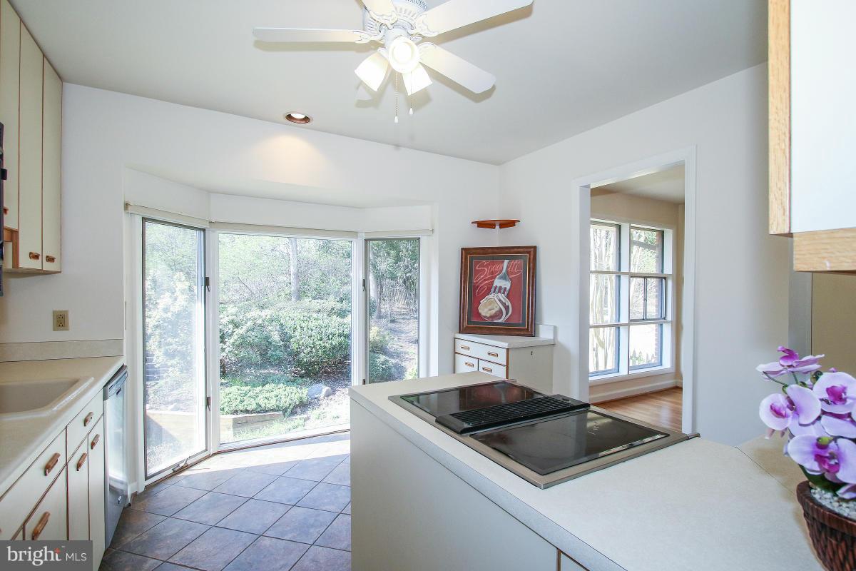 7708 Beech Tree Road Bethesda, MD 20817 - Photo 12 of 30 a kitchen with a stove a sink and a window