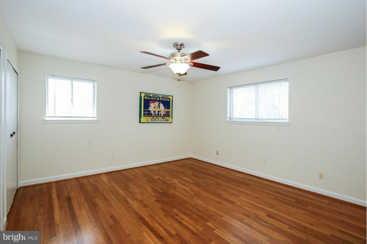 7708 Beech Tree Road Bethesda, MD 20817 - Photo 16 of 30 a view of an empty room with wooden floor and a window