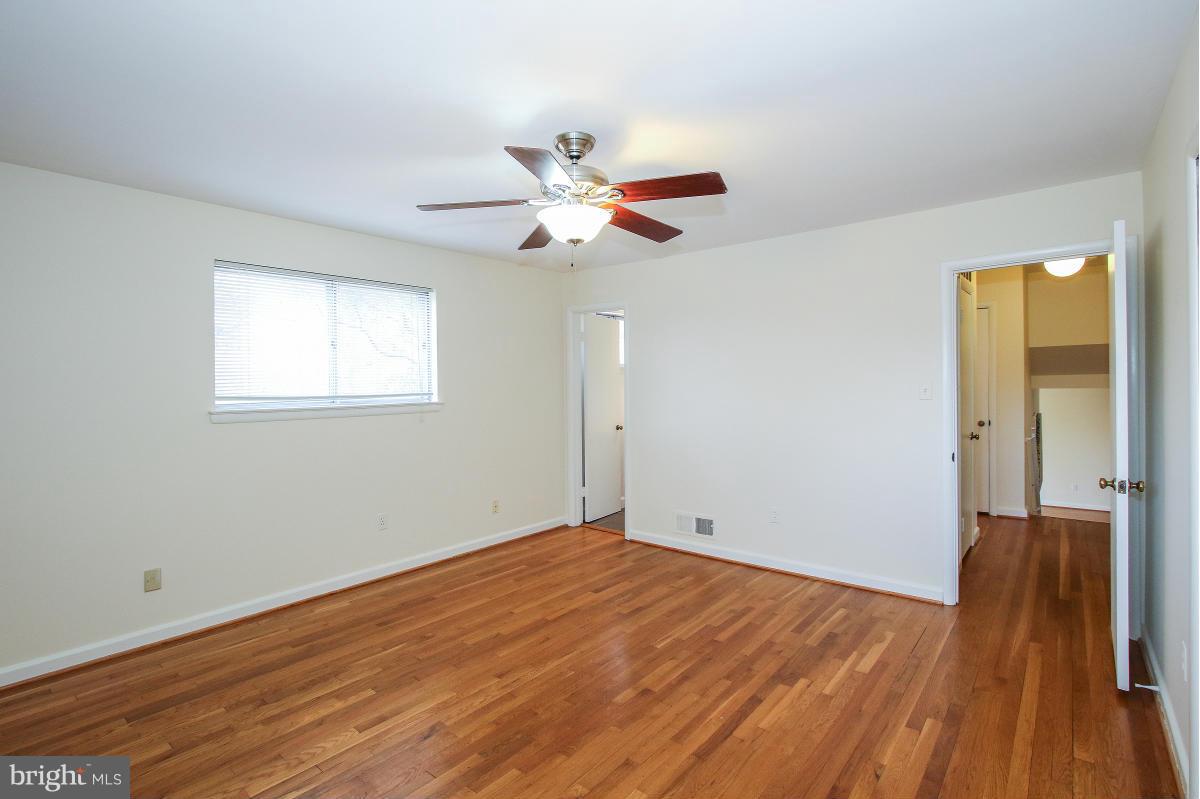 7708 Beech Tree Road Bethesda, MD 20817 - Photo 17 of 30 wooden floor in an empty room with a window