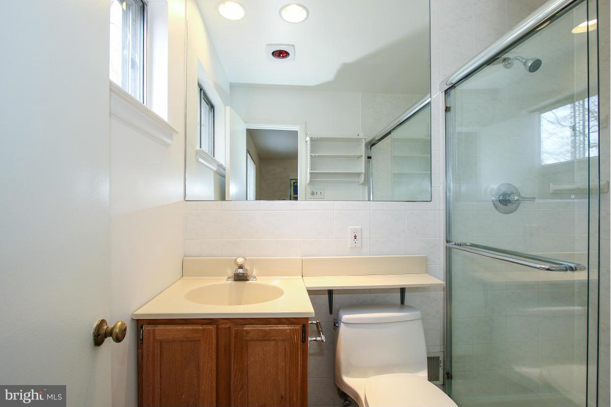 7708 Beech Tree Road Bethesda, MD 20817 - Photo 18 of 30 a bathroom with a sink a toilet and shower