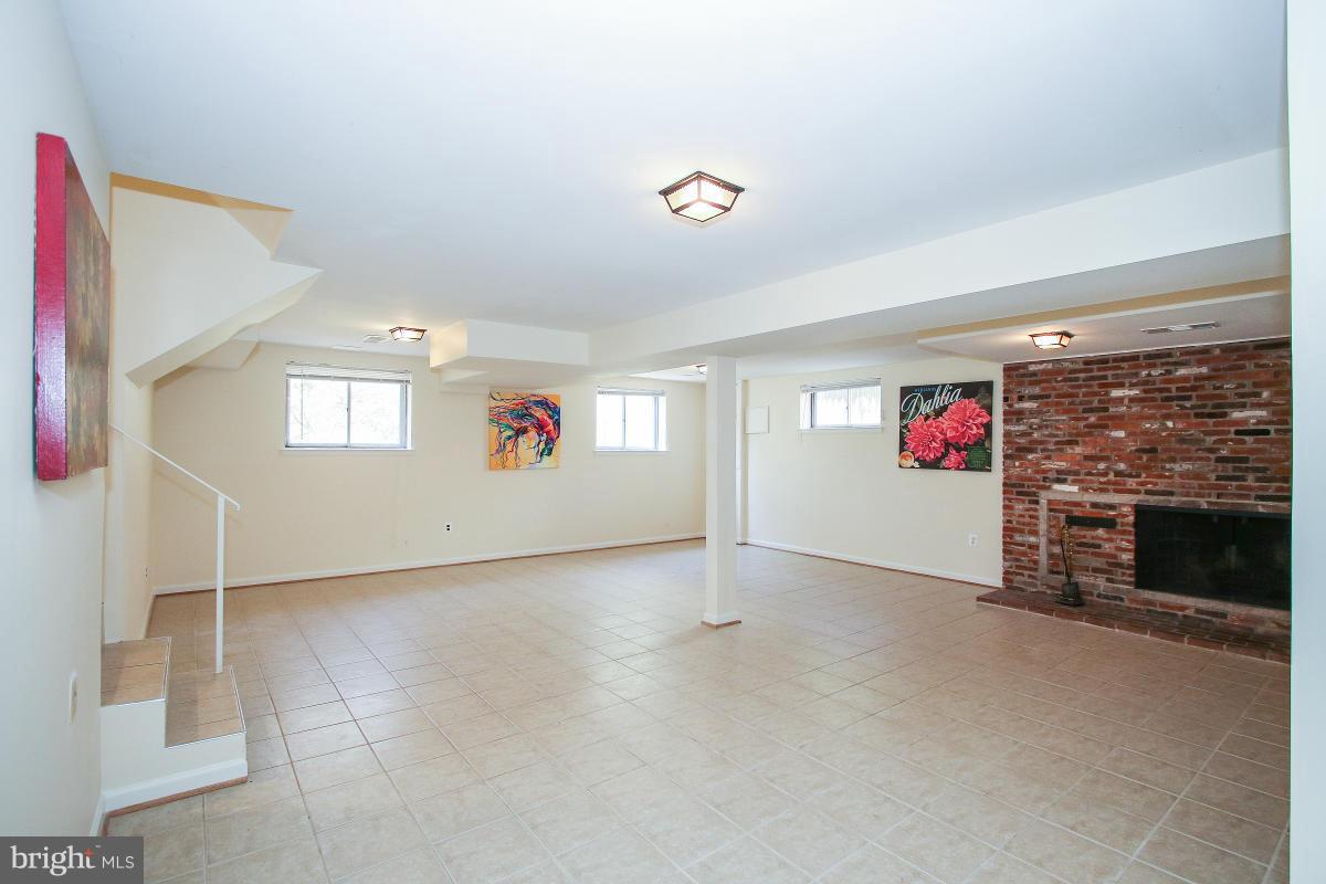 7708 Beech Tree Road Bethesda, MD 20817 - Photo 22 of 30 an empty room with windows and fireplace