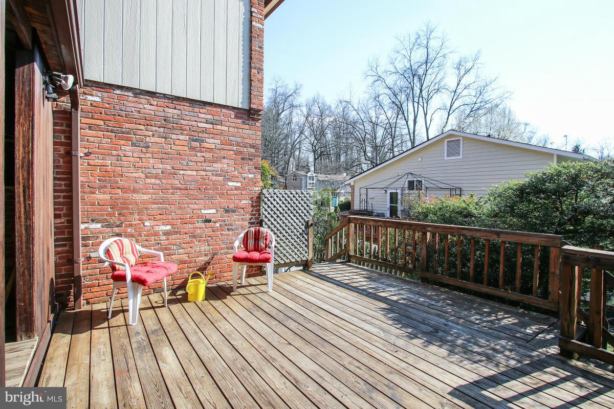 7708 Beech Tree Road Bethesda, MD 20817 - Photo 28 of 30 a balcony with wooden floor and trees