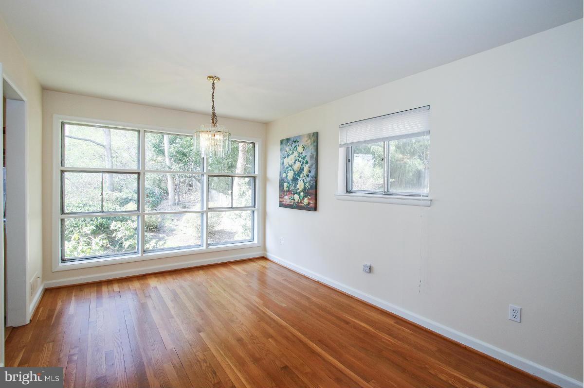 7708 Beech Tree Road Bethesda, MD 20817 - Photo 7 of 30 a big room with wooden floor and windows