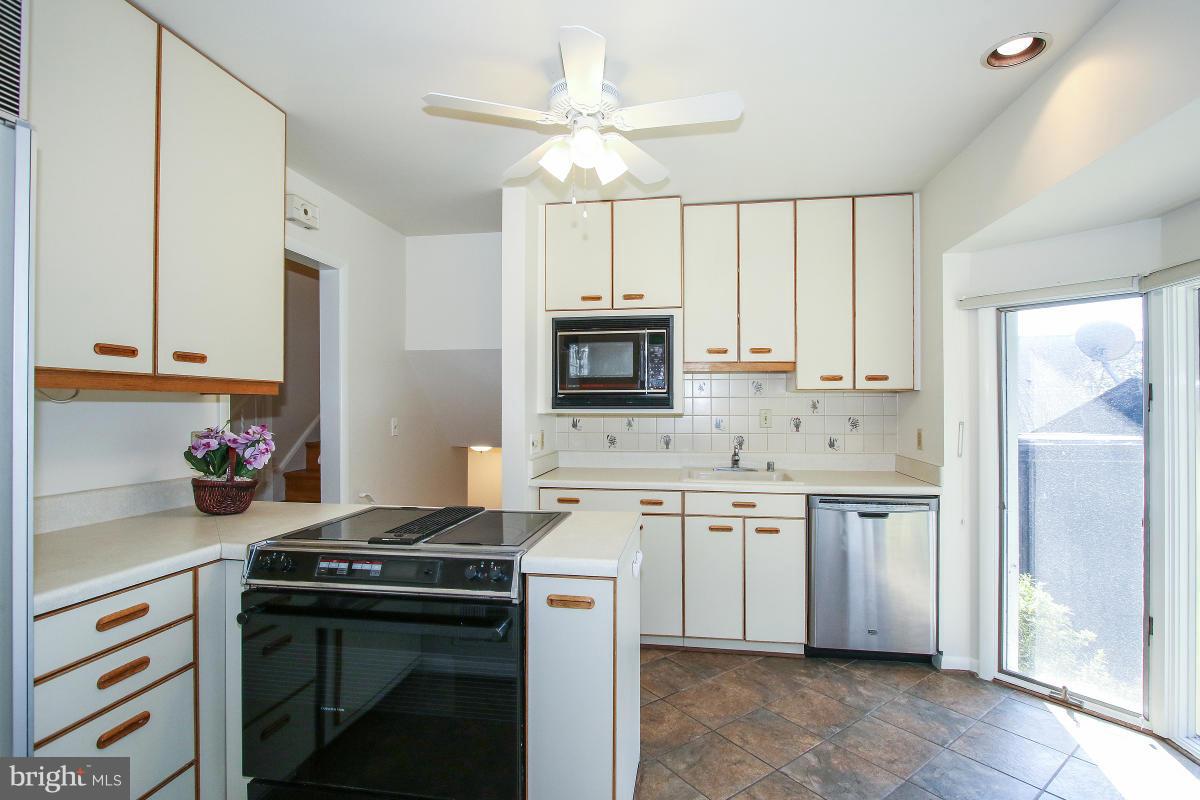 7708 Beech Tree Road Bethesda, MD 20817 - Photo 9 of 30 a kitchen with stainless steel appliances a stove a sink and a refrigerator