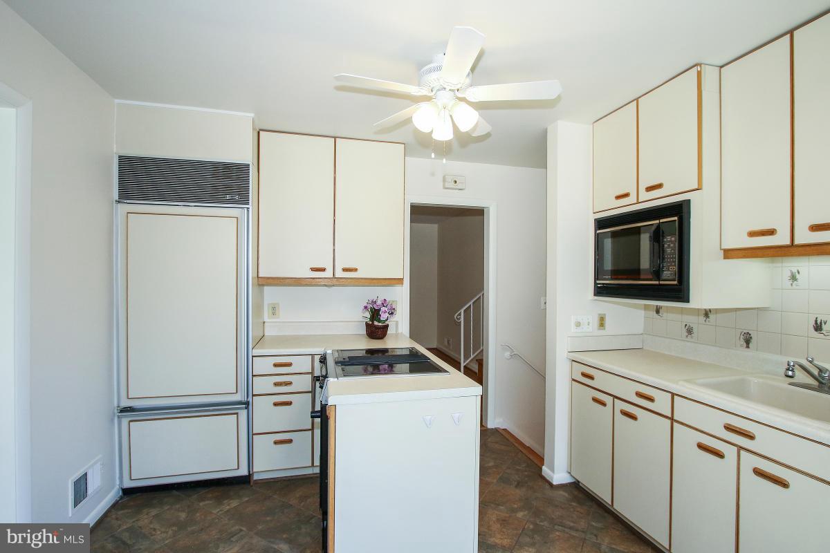 7708 Beech Tree Road Bethesda, MD 20817 - Photo 10 of 30 a kitchen with a refrigerator sink and stove