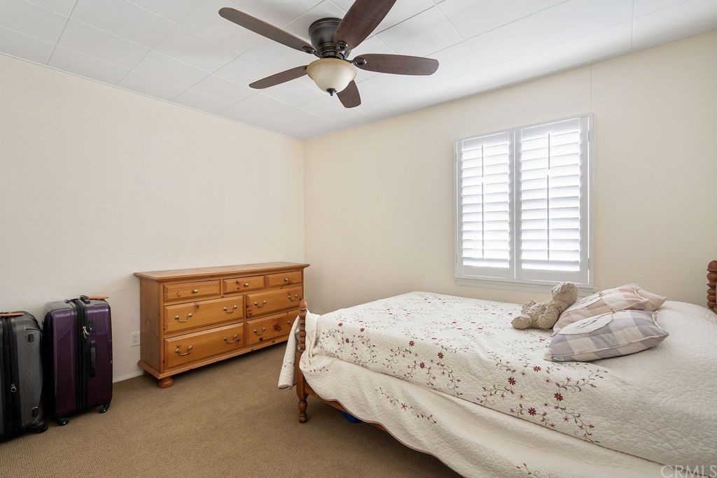 671 Olive Street Upland, CA 91786 - Photo 24 of 47 a bedroom with a bed and a ceiling fan