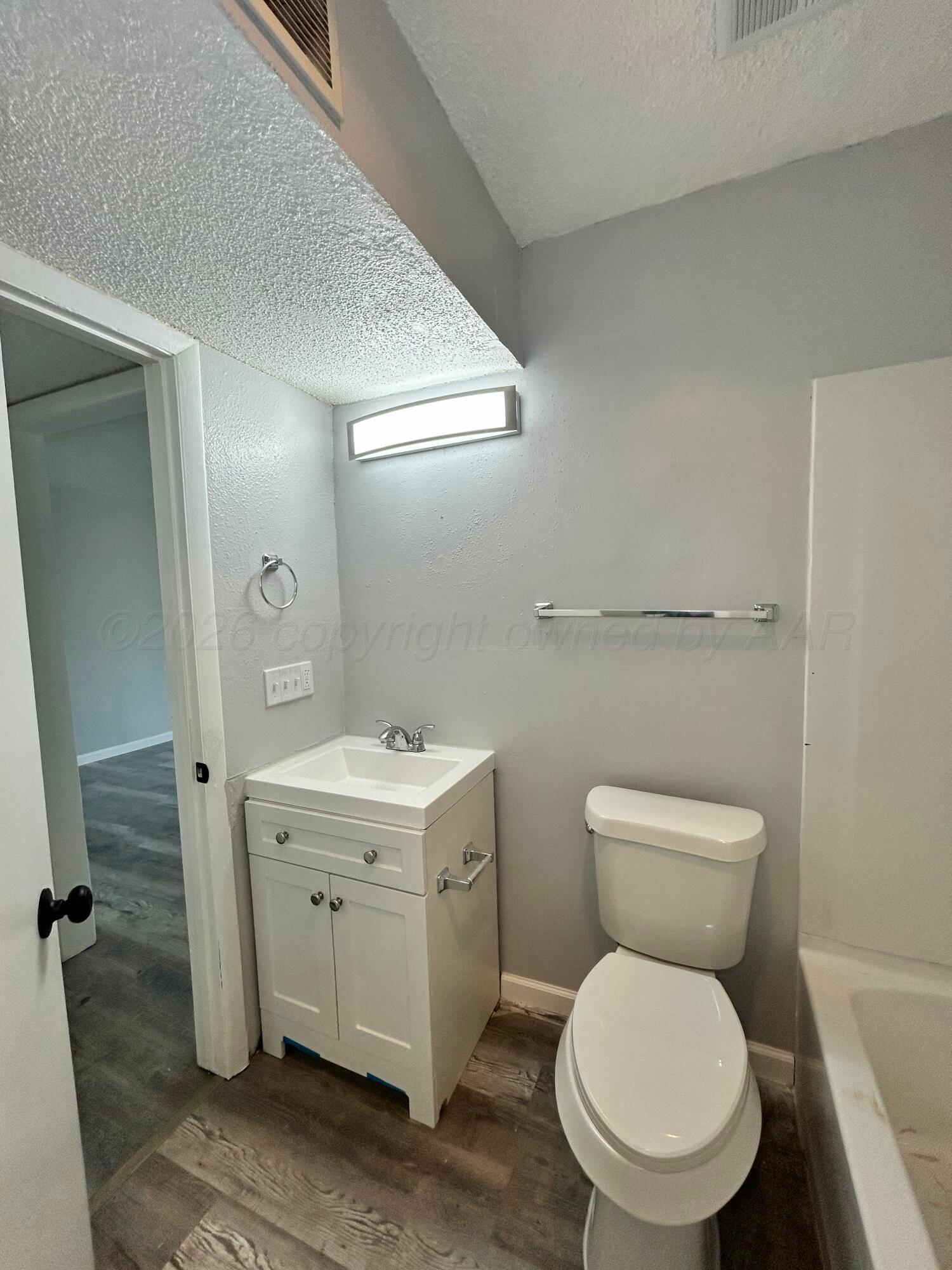 3020 Southwest 27th Avenue Amarillo, TX 79109 - Photo 13 of 18 a white toilet sitting next to a bathroom sink