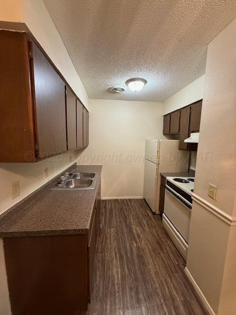 3020 Southwest 27th Avenue Amarillo, TX 79109 - Photo 7 of 18 a kitchen with a sink and a refrigerator