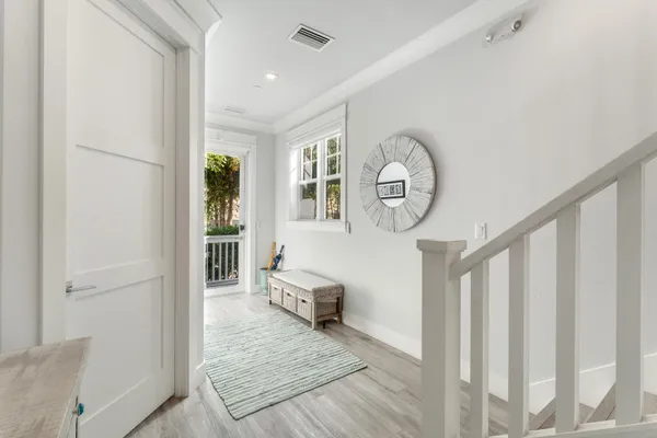 a view of a hallway with wooden floor