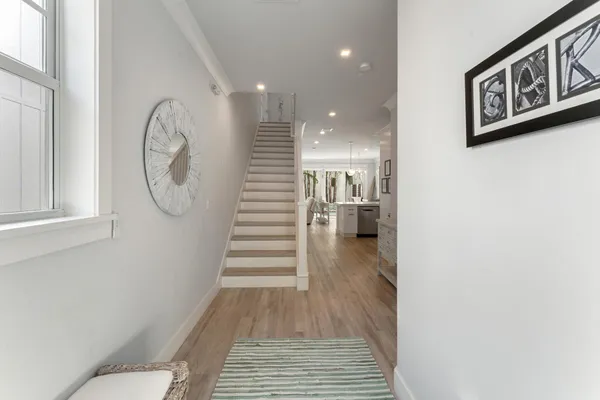 a view of a room with wooden floor and stairs