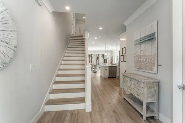 a bedroom with a bed a table and windows