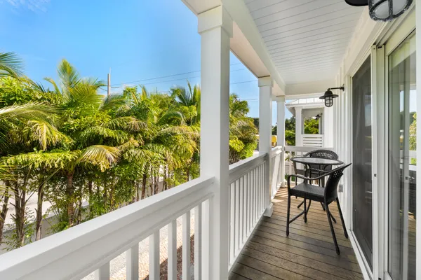 a view of a house with a yard and potted plants