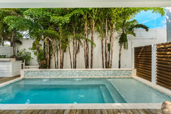 a view of a swimming pool with outdoor seating