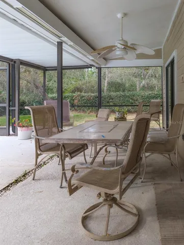 a kitchen that has a lot of white cabinets a sink and appliances