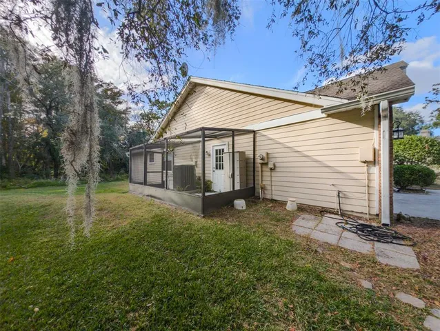 a view of house with backyard space and balcony