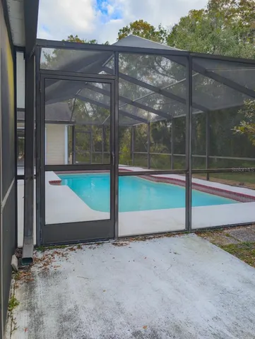 a view of a field with trees in the background