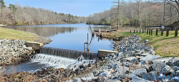 a view of a lake with a bench next to a lake