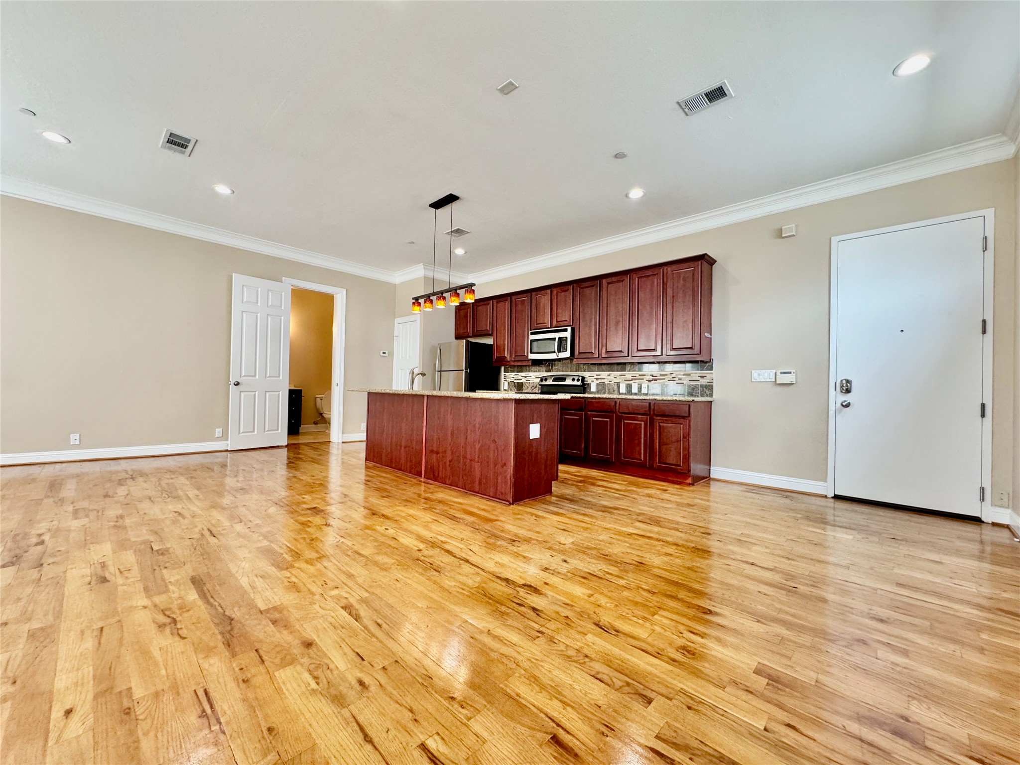314 West Bell Street, Unit 201 Houston, TX 77019 - Photo 12 of 32 a view of an empty room with kitchen and a window