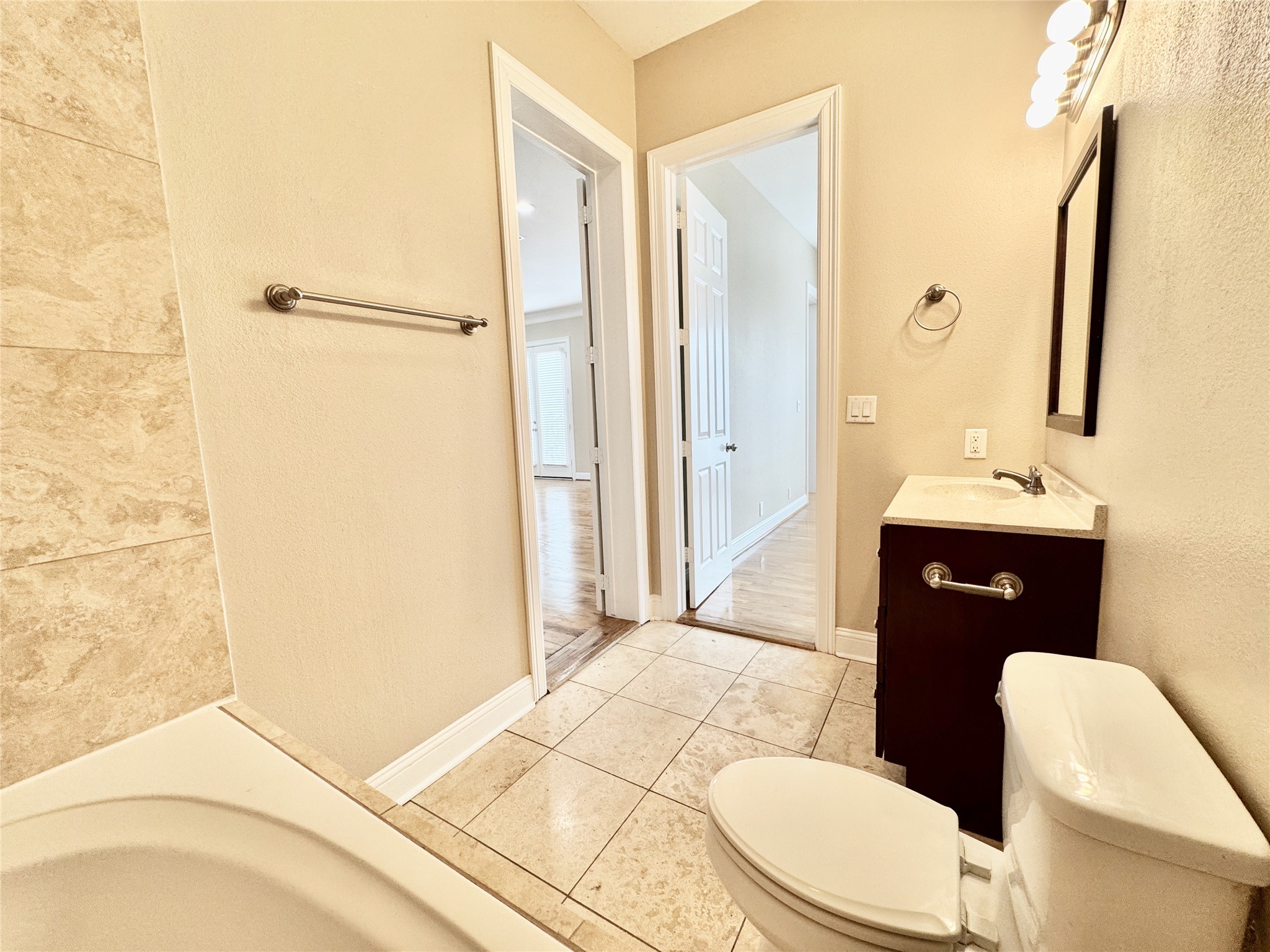 314 West Bell Street, Unit 201 Houston, TX 77019 - Photo 21 of 32 a bathroom with a sink a toilet a mirror and shower