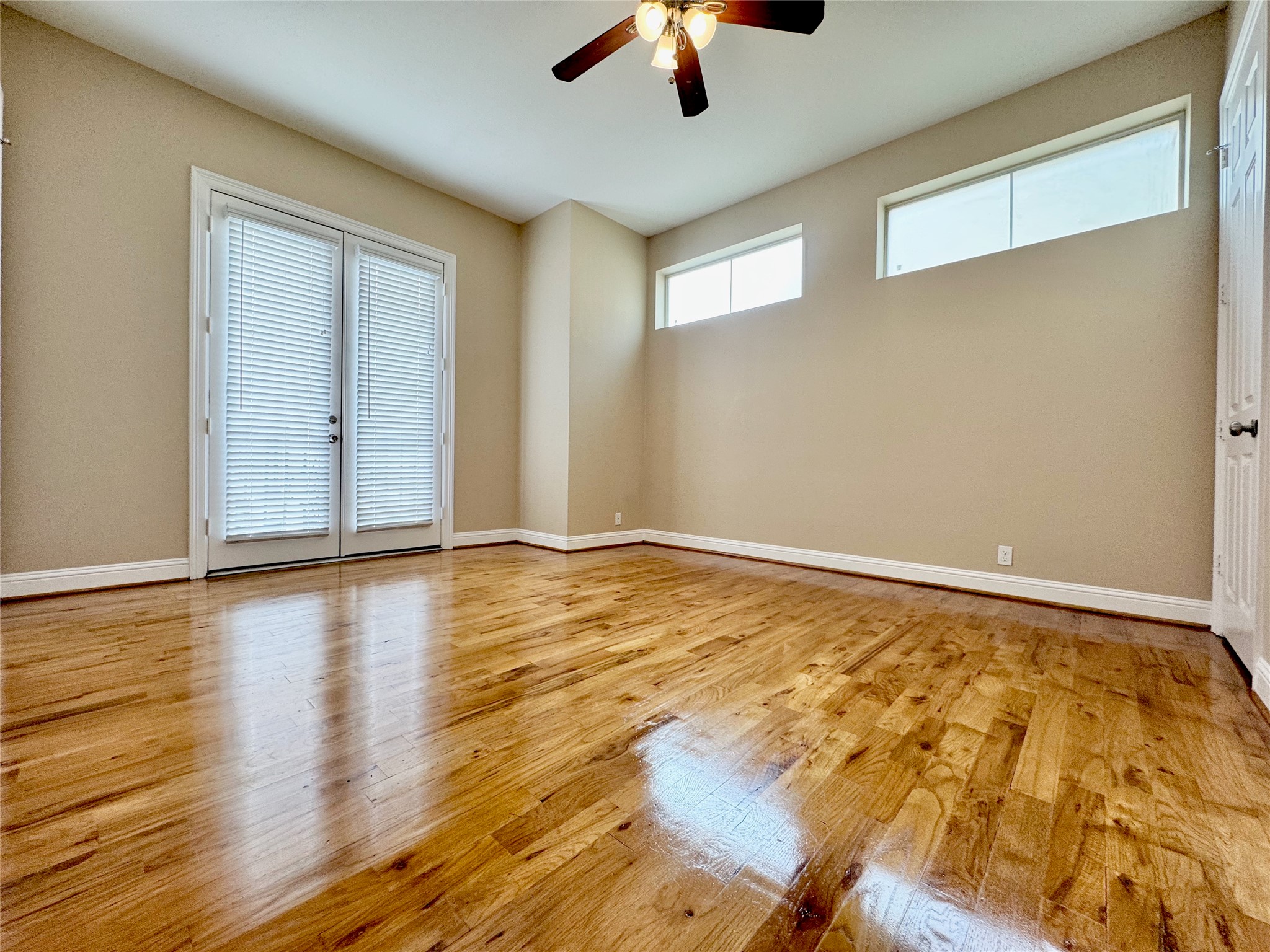 314 West Bell Street, Unit 201 Houston, TX 77019 - Photo 22 of 32 a view of an empty room with wooden floor and a window