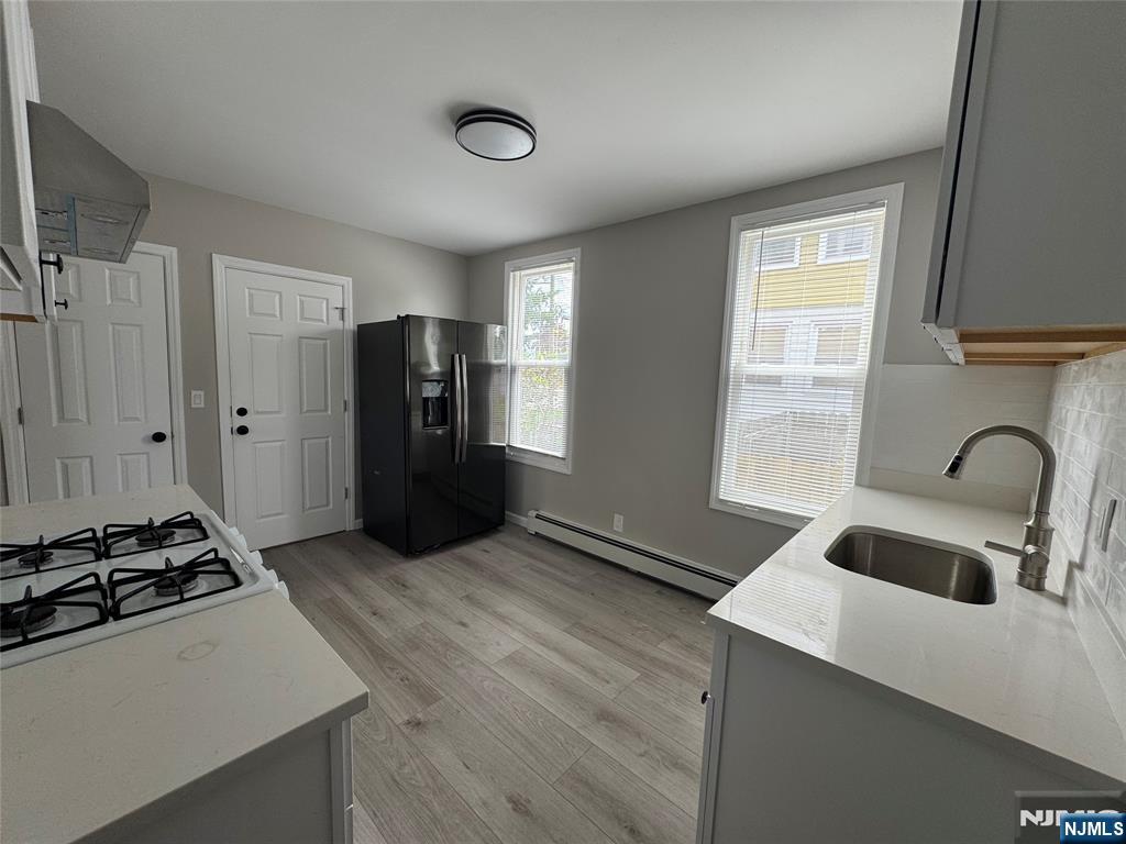 138 Carlton Avenue East Rutherford, NJ 07073 - Photo 4 of 14 a kitchen with stainless steel appliances granite countertop a refrigerator and a stove top oven