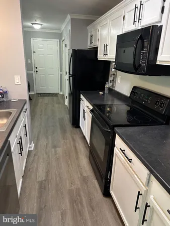 a kitchen with a stove a refrigerator and a microwave