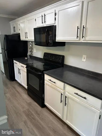 a kitchen with stainless steel appliances granite countertop a stove a microwave and a refrigerator