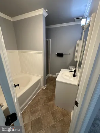 a bathroom with a bathtub and shower