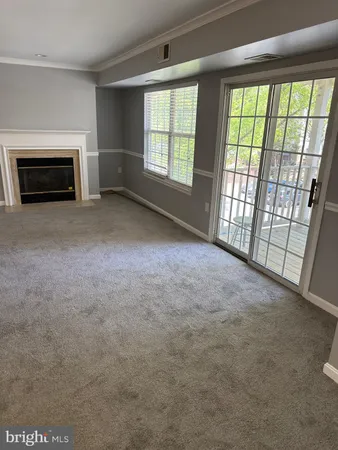an empty room with furniture and a fireplace