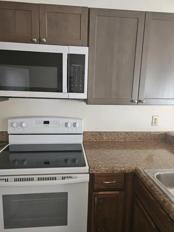 a bathroom with a granite countertop sink mirror vanity and bathtub