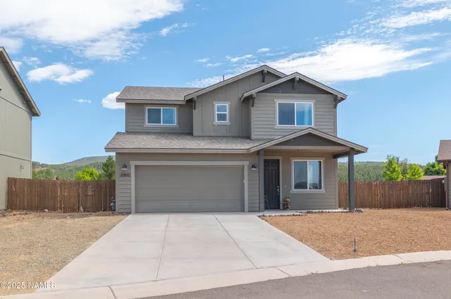 a front view of a house with a yard and a garage
