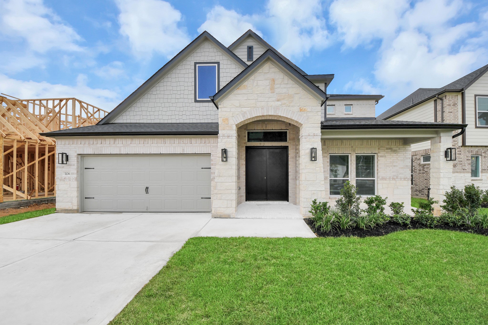3106 Native Spg Drive Spring, TX 77373 - Photo 3 of 47 Meticulously maintained yard and lush landscape, paired with a premium elevation featuring captivating brick accents. Modern coach lights add a touch of contemporary elegance to the exterior.
