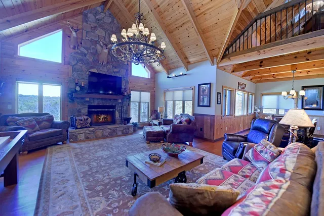 a view of a dining room with furniture a chandelier and wooden floor