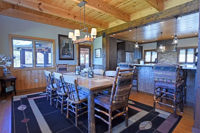 a living room with furniture a flat screen tv and floor to ceiling window