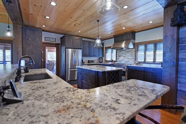 a bedroom with a large bed and wooden floor