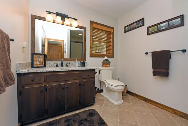 a view of a house with brick walls and a yard with wooden fence