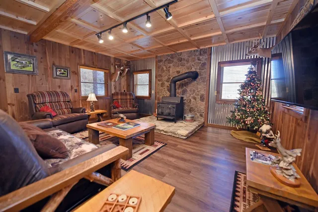 a living room with furniture a flat screen tv and a chandelier