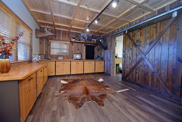 a view of a dining room with furniture a chandelier and wooden floor