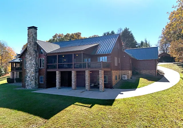 a living room with furniture a chandelier and a fireplace