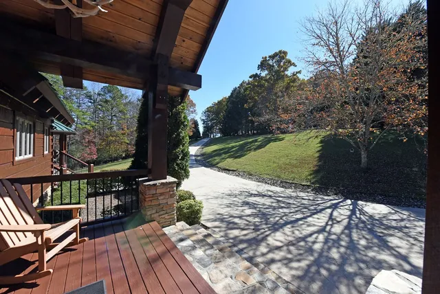 a living room with furniture a fireplace and a chandelier