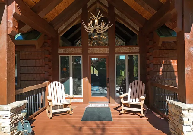 a living room with lots of furniture and chandelier