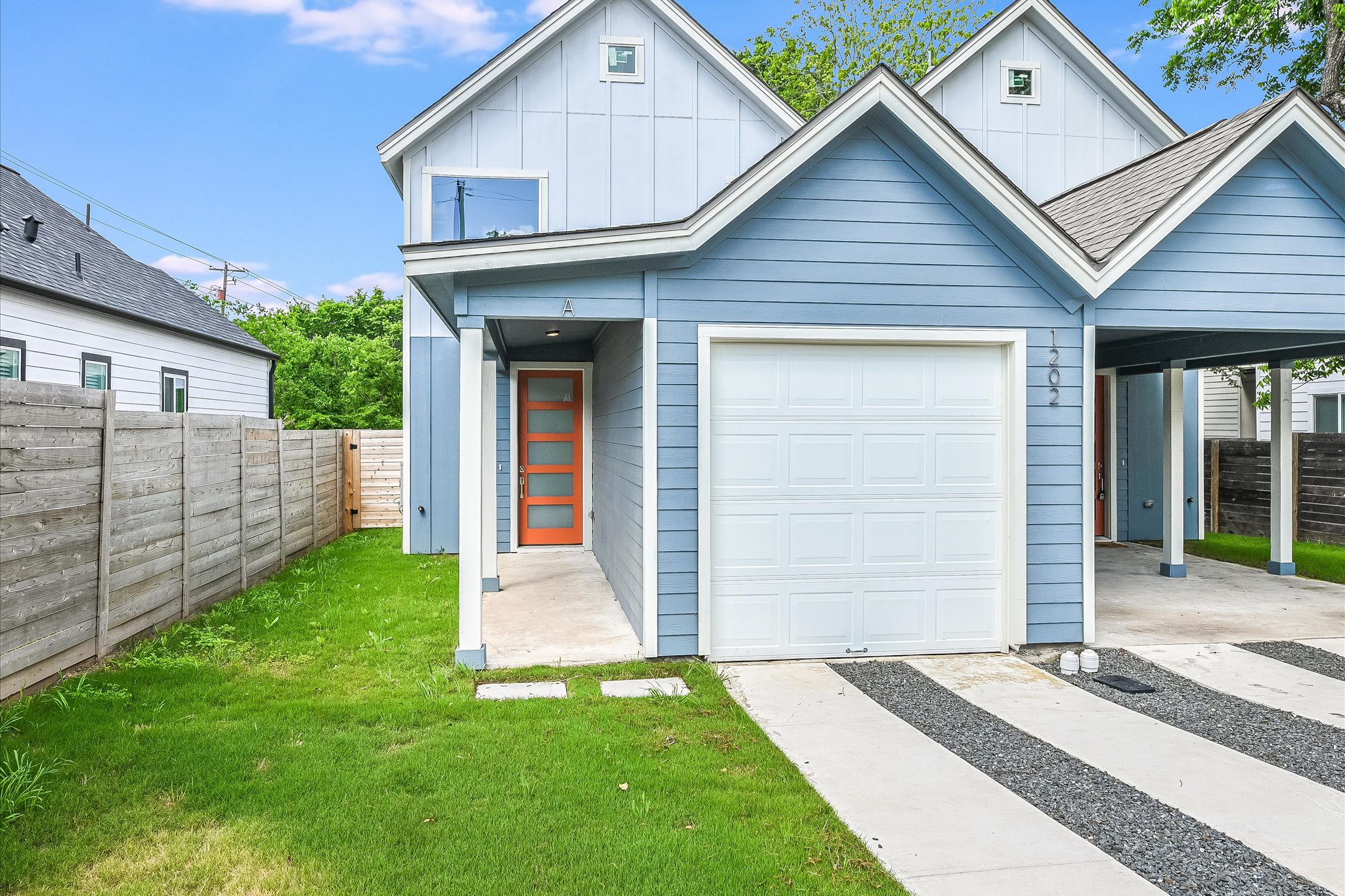 1202 Cometa Street, Unit B Austin, TX 78721 - Photo 1 of 1 a front view of a house with a yard and garage