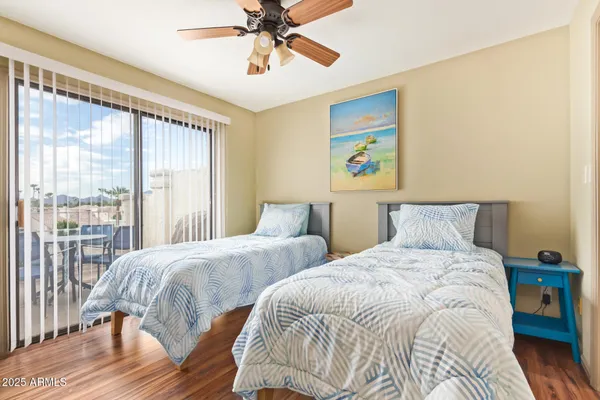 a bedroom with two beds and a large window
