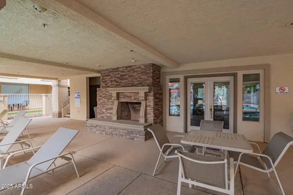 a living room with furniture a fireplace and a table